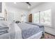 Inviting bedroom featuring large windows, shutter, and stylish bedding, creating a serene atmosphere at 1175 Jackson Rd, Clearwater, FL 33755
