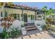 Charming front porch with colorful tiled steps and black pergola, framed by lush greenery at 1175 Jackson Rd, Clearwater, FL 33755