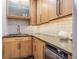 Stylish kitchen with stainless steel under counter refrigerator, sleek countertops, and wooden cabinets with modern hardware at 1175 Jackson Rd, Clearwater, FL 33755