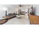 Open living room featuring tile flooring, a unique sofa, a modern fireplace, and stylish decor with a retro vibe at 1175 Jackson Rd, Clearwater, FL 33755