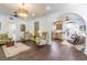 Living room boasting hardwood floors, arched entryways, stylish seating, and views to the kitchen at 1175 Jackson Rd, Clearwater, FL 33755