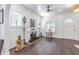 Elegant living room featuring a decorative fireplace, dark hardwood flooring, and artful decor with abundant natural light at 1175 Jackson Rd, Clearwater, FL 33755