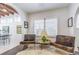 Bright living room features shuttered windows, decorative lighting, and an open floor plan at 1175 Jackson Rd, Clearwater, FL 33755