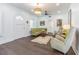 Bright living room with hardwood floors, white walls, an archway, and elegant furnishings, creating a cozy atmosphere at 1175 Jackson Rd, Clearwater, FL 33755