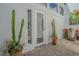 Private patio featuring lush plantings and a door to the interior of the home at 1175 Jackson Rd, Clearwater, FL 33755