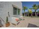 Cozy patio area with modern chairs, vibrant palm trees, and a serene ambiance at 1175 Jackson Rd, Clearwater, FL 33755