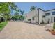 Expansive patio with a grill, lounge seating and beautiful landscaping leading to the pool area at 1175 Jackson Rd, Clearwater, FL 33755