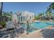 In-ground pool with lounge seating, a nearby spa, and lush surrounding greenery, perfect for relaxation at 1175 Jackson Rd, Clearwater, FL 33755