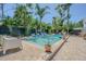 Inviting pool area with tile surround, lush landscaping and cozy patio seating at 1175 Jackson Rd, Clearwater, FL 33755
