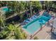 Inviting backyard oasis featuring a sparkling pool, lush landscaping, and comfortable lounge chairs at 1175 Jackson Rd, Clearwater, FL 33755