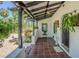 Inviting front porch with tile flooring, hanging plants, and a decorative railing at 1175 Jackson Rd, Clearwater, FL 33755