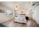 Well-lit bedroom features modern furnishings, decor, and laminate floors at 118 94Th Ave, Treasure Island, FL 33706