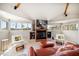 Bright living room with fireplace, flat screen TV, comfortable seating, and multiple windows at 118 94Th Ave, Treasure Island, FL 33706