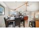 Open concept living space with a vaulted ceiling, large dining room table, and an entertainment area at 118 94Th Ave, Treasure Island, FL 33706