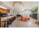 Open-concept living area with vaulted ceilings, tile floors, and a cozy fireplace at 118 94Th Ave, Treasure Island, FL 33706