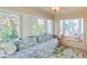 Inviting sitting area with a daybed, lots of windows, and beachy decor at 118 94Th Ave, Treasure Island, FL 33706