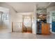 Entryway with a wet bar featuring a wine cooler, sink, mirrored backsplash and decorative display shelves at 118 94Th Ave, Treasure Island, FL 33706