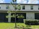 Back view of home exterior showing the screened-in patio and backyard landscaping at 11823 Dumaine Valley Rd, Riverview, FL 33579