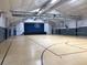 Spacious gym including basketball hoops and a stage area at 11823 Dumaine Valley Rd, Riverview, FL 33579
