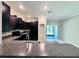 Kitchen featuring dark cabinets, granite counters, and stainless appliances at 11823 Dumaine Valley Rd, Riverview, FL 33579