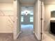 An open doorway leads to a spacious carpeted primary bedroom at 11823 Dumaine Valley Rd, Riverview, FL 33579