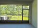 A screened lanai offering serene views of the lush green backyard, accessible from the main living space at 11823 Dumaine Valley Rd, Riverview, FL 33579