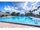 A large community swimming pool with ample lounge chairs and a clear blue sky at 11823 Dumaine Valley Rd, Riverview, FL 33579