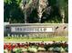 Community sign at Summerfield featuring flowers and stone design near entry at 11823 Dumaine Valley Rd, Riverview, FL 33579