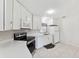 Well-lit kitchen featuring white cabinets, modern appliances, and tiled flooring at 12430 Oconee Blvd, New Port Richey, FL 34654