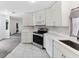 Contemporary kitchen boasting white cabinets, stainless appliances, and sleek countertops at 12430 Oconee Blvd, New Port Richey, FL 34654