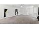 Expansive living room with neutral carpet, white walls, and plenty of natural light at 12430 Oconee Blvd, New Port Richey, FL 34654