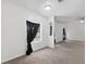 Inviting living area featuring neutral carpet, white walls, and ample lighting at 12430 Oconee Blvd, New Port Richey, FL 34654