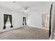 Bright primary bedroom with carpeted floors and ensuite bathroom at 12430 Oconee Blvd, New Port Richey, FL 34654