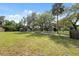 Large yard with mature trees and parking area at 12430 Oconee Blvd, New Port Richey, FL 34654