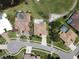 Aerial view of a single-story home in a golf course community featuring a private pool and circular driveway at 1311 Fallsmeade Ct, Oldsmar, FL 34677