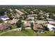 Aerial view of a well-maintained neighborhood with golf courses, lakes, and various home styles at 1311 Fallsmeade Ct, Oldsmar, FL 34677