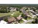 Aerial view of a golf community with homes surrounding a pristine golf course, ponds and lush landscaping at 1311 Fallsmeade Ct, Oldsmar, FL 34677