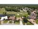 Elevated view of a single-story home on a golf course, showcasing lush landscaping and mature trees at 1311 Fallsmeade Ct, Oldsmar, FL 34677