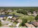 Panoramic aerial of homes on a golf course with lush landscaping and mature trees in a residential community at 1311 Fallsmeade Ct, Oldsmar, FL 34677