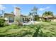 Expansive backyard featuring a sparkling pool, outdoor seating, and lush landscaping at 1311 Fallsmeade Ct, Oldsmar, FL 34677