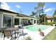 Lush backyard with a pool and golf course views, creating a serene and inviting space for outdoor living and entertaining at 1311 Fallsmeade Ct, Oldsmar, FL 34677