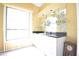 Bright wet bar with sleek white cabinetry, granite countertop, and glassware shelves for entertaining guests at 1311 Fallsmeade Ct, Oldsmar, FL 34677