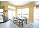 Bright dining area featuring a table with seating and natural light from large windows at 1311 Fallsmeade Ct, Oldsmar, FL 34677