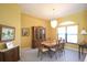Dining room with a wooden table set for six, neutral carpet and traditional decor at 1311 Fallsmeade Ct, Oldsmar, FL 34677