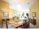 A dining room set up with gold chargers and a view to the living room at 1311 Fallsmeade Ct, Oldsmar, FL 34677