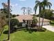 Charming single-story home with lush landscaping, a well-maintained lawn, and a spacious three-car garage at 1311 Fallsmeade Ct, Oldsmar, FL 34677