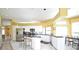Bright kitchen with stainless appliances, island seating, and an open layout at 1311 Fallsmeade Ct, Oldsmar, FL 34677