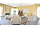 Bright living room featuring comfortable seating, a fireplace, a television, and large windows for ample natural light at 1311 Fallsmeade Ct, Oldsmar, FL 34677