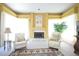 Living room featuring a fireplace, comfortable seating, and large windows providing ample natural light and a cozy ambiance at 1311 Fallsmeade Ct, Oldsmar, FL 34677