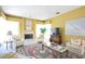 Cozy living room featuring a fireplace, plush seating, a decorative rug, and ample natural light from large windows at 1311 Fallsmeade Ct, Oldsmar, FL 34677